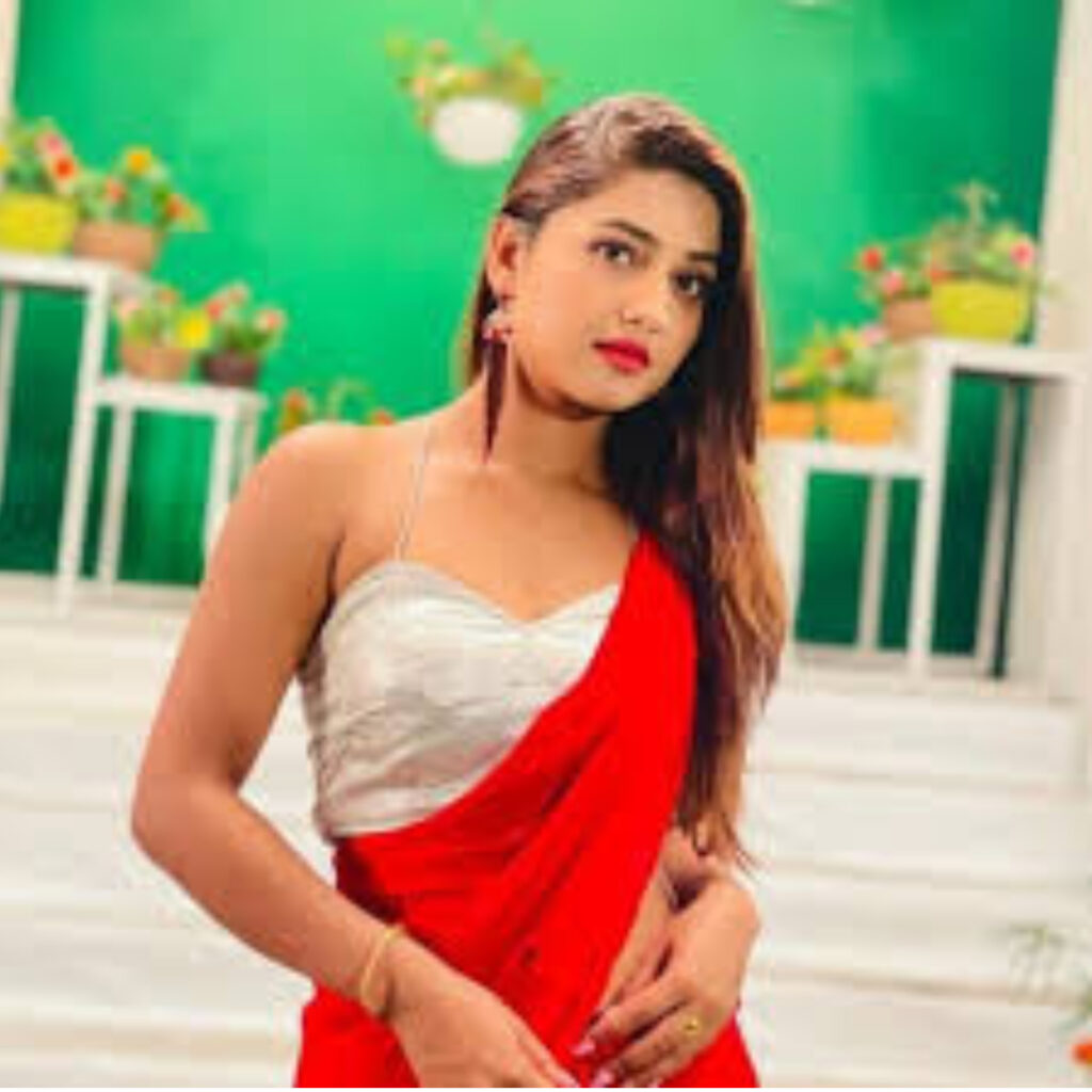 A GIRL 23 YEARS OLD NAME IS KOMAL WAERING RED SAREE AND WHITE BLOUSE GIVING SEXY POSE IN STANDING POSITION